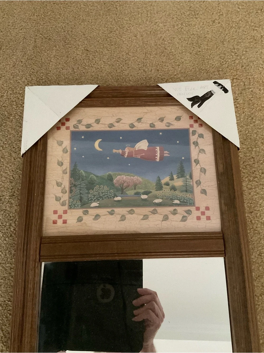 Vintage wood-framed trumeau mirror with a folk art print